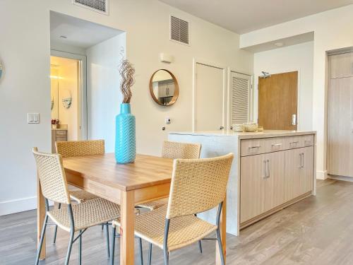 a dining room with a wooden table and chairs at Stunning Apartment By Petco Park! in San Diego