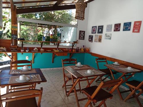 een eetkamer met houten tafels en stoelen bij Hawaii Flats in São Miguel do Gostoso