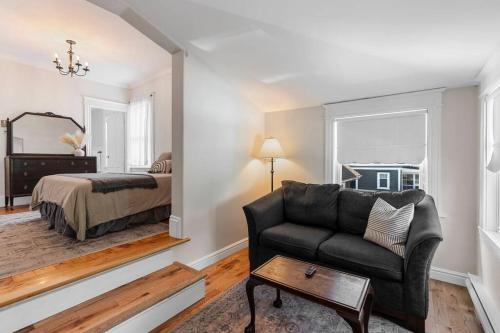 a living room with a couch and a bed at Studio 7 ~ 1 BDRM w/ Private Bath & Living Room in Moncton