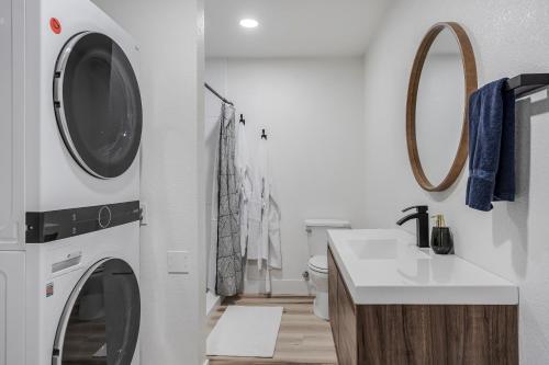 a bathroom with a washer and dryer next to a sink at Avocado Bliss Retreat in Valley Center