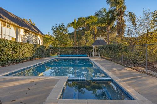 a swimming pool in the backyard of a house at Avocado Bliss Retreat in Valley Center