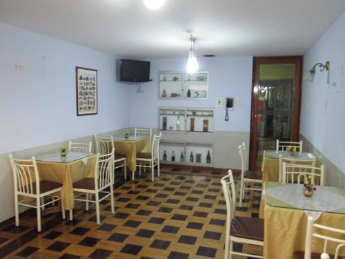a restaurant with tables and chairs in a room at Hotel Panamericano in Lima