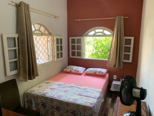 um quarto com uma cama e duas janelas em Apto Florescer - No Espaço Florescer em Campos dos Goytacazes