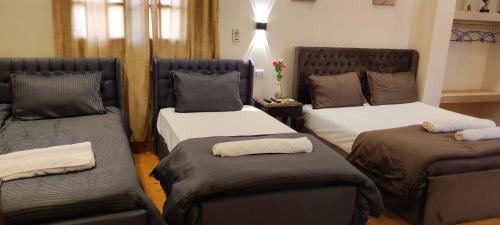 a room with two beds with brown pillows at Hur magic inn in Cairo