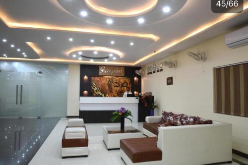 a lobby with a waiting area with a couch and chairs at HOTEL MARIYA INTERNATIONAL in Bodh Gaya