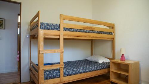 a bedroom with two bunk beds with a ladder at Casa do Avô Machado in Abrantes