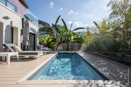 a swimming pool in the backyard of a house at GROUND FLOOR VILLA GRAZIELLA 200 M FROM THE BEACH in Èze