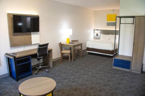 a hotel room with a bed and a desk and a bedroom at Comfort Inn Sioux City South in Morningside