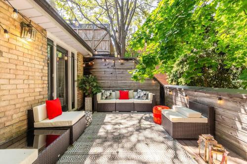 a patio with couches and chairs on a house at Sweet Home in Toronto