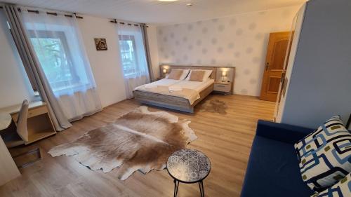 a living room with a bed and a rug on the floor at Rooms 4 Holiday in Kirchbach