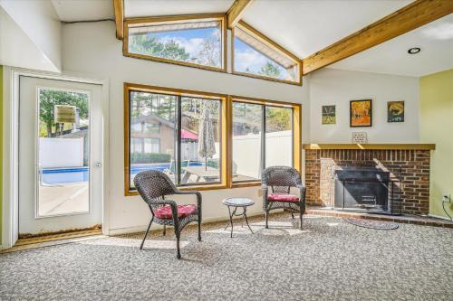 a living room with three chairs and a fireplace at Cedarbrook Deluxe one bedroom suite with outdoor heated pool 11921 in Killington