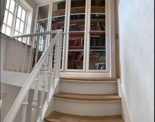 a staircase with a book shelf with books at Villa Rørby - Nordsoe Housing in Kalundborg