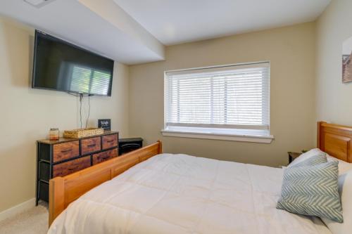 a bedroom with a bed and a flat screen tv at Spacious and Serene Lake Ridge Retreat with Game Room! in Woodbridge