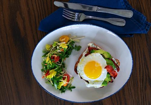 a plate of food with an egg and a salad at Four Points by Sheraton Tucson Airport in Tucson