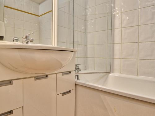 a white bathroom with a sink and a bath tub at Appartement Flumet, 2 pièces, 4 personnes - FR-1-505-110 in Flumet