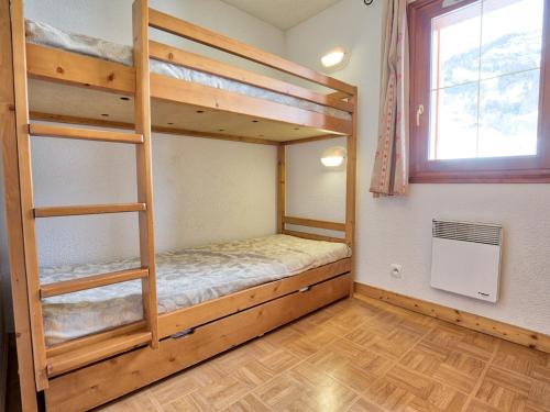 a bedroom with two bunk beds and a window at Appartement Flumet, 3 pièces, 6 personnes - FR-1-505-109 in Flumet