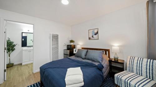 a bedroom with a bed and a chair at Adventure Lodge in South Lake Tahoe