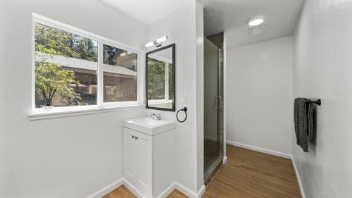 a white bathroom with a sink and a mirror at Adventure Lodge in South Lake Tahoe