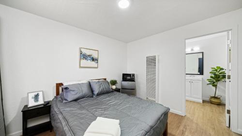 a bedroom with a bed in a white room at Adventure Lodge in South Lake Tahoe
