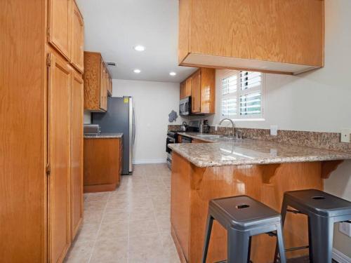 a kitchen with wooden cabinets and a counter top at Charming 4BR Retreat - Near Old Town Monrovia in Monrovia