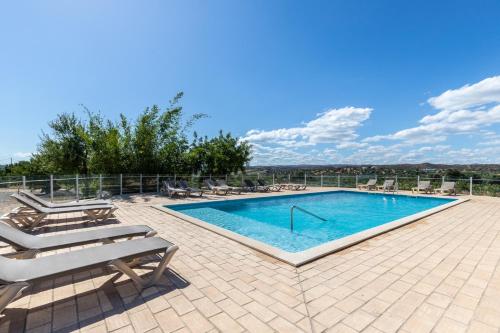 a swimming pool with lounge chairs and ahaps at RMR Charme & Vistas @ T3 Duplex in Tavira