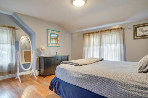 a bedroom with a bed and a dresser and a mirror at 1 Mi to Windmill Beach South Yarmouth Apt! in Yarmouth