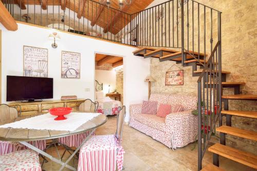 a living room with a staircase and a table at Case del Vicolo Stretto in Modica