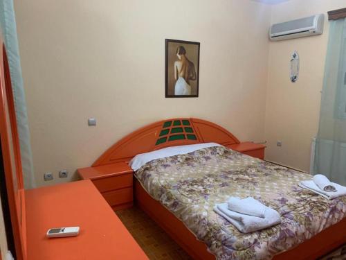 a bedroom with a bed with two towels on it at Lovely flat in the heart of Korca #1 in Korçë