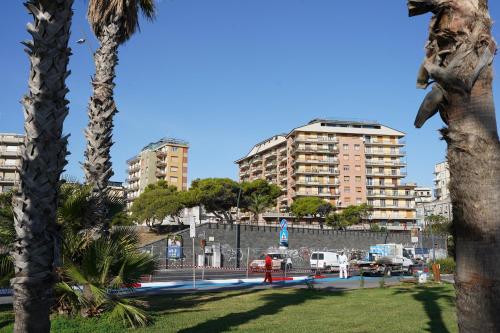 a city with tall buildings and palm trees at R-HOME Li Cuti in Catania