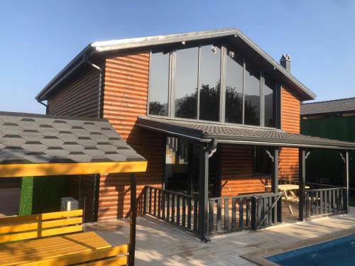 a house with a deck and a swimming pool at SAPANCA FAMİLY RESORT in Kartepe