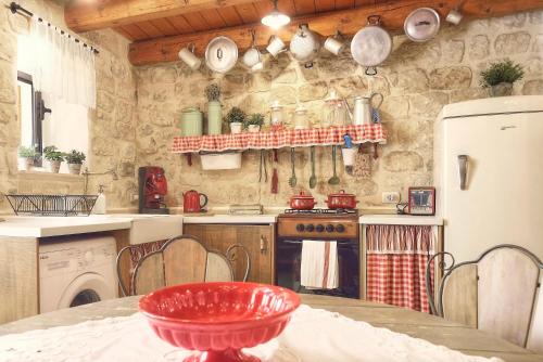 a kitchen with a red bowl on a table at Case del Vicolo Stretto in Modica
