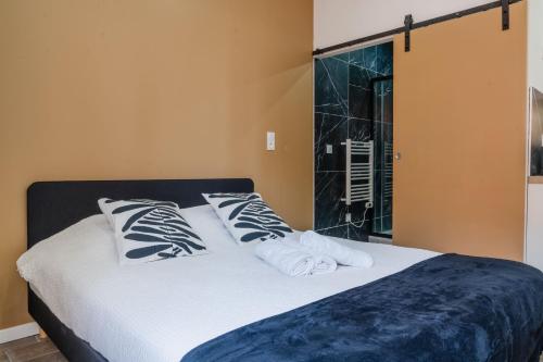 a bed with black and white pillows in a room at Studio Nicehome Massena in Nice