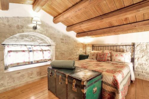 a bedroom with a bed and a large window at Case del Vicolo Stretto in Modica