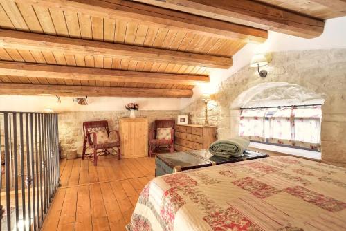 a bedroom with a bed and a table and chairs at Case del Vicolo Stretto in Modica