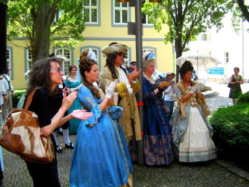 a group of women dressed in historical clothing standing at Goethe Hotel in Bad Pyrmont