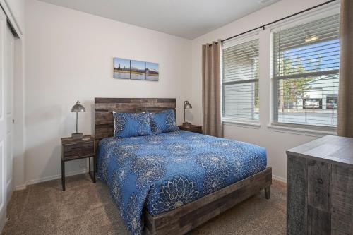 a bedroom with a blue bed and a window at 172 Avocet home in Sunriver