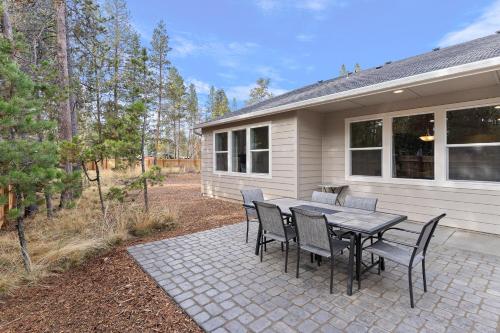 a patio with a table and chairs in front of a house at 172 Avocet home in Sunriver
