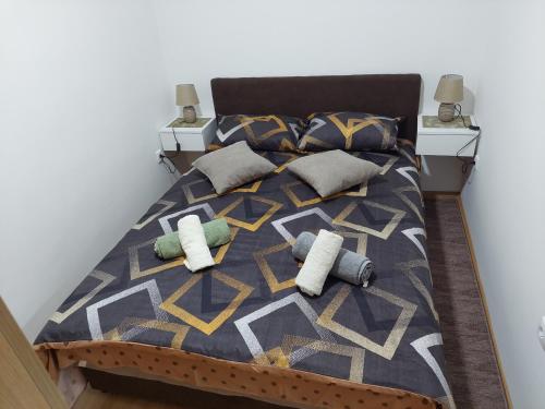 a bed with two pillows and a blanket at DAN 9 in Sombor