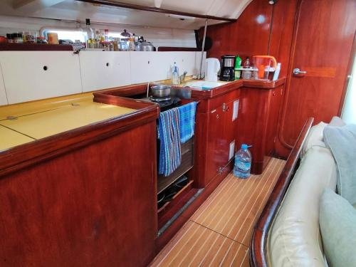 a kitchen with a stove and a counter top at Boat Maeva in Gourbeyre