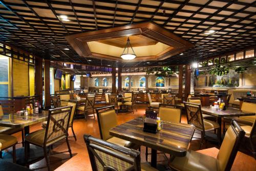 a restaurant with tables and chairs in a room at Eldorado Reno, A Caesars Destination in Reno