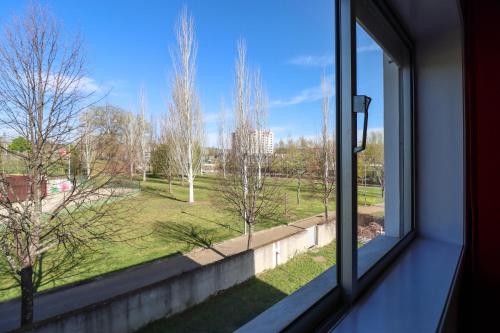 a window with a view of a park at Guest House Chaves in Chaves