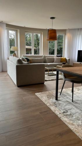 a living room with a couch and a table at LES GITES DE LA KARLSMUHLE in Haguenau