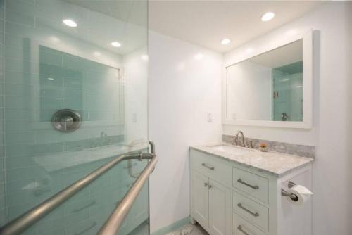 a bathroom with a shower and a sink and a mirror at Coastal Zen Cottage - Walk To Beach in Half Moon Bay