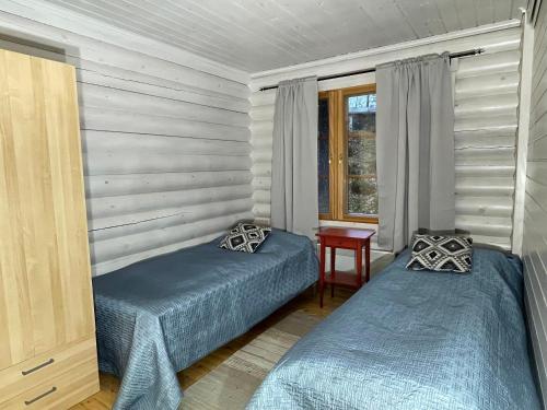 Villa Saimaa में एक कमरे में एक या कई बेड