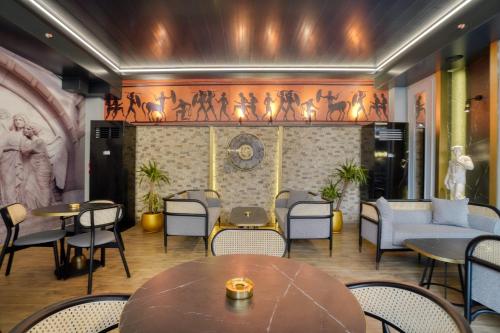 a restaurant with tables and chairs and a wall with a mural at İbos Hotels Izmir in Izmir