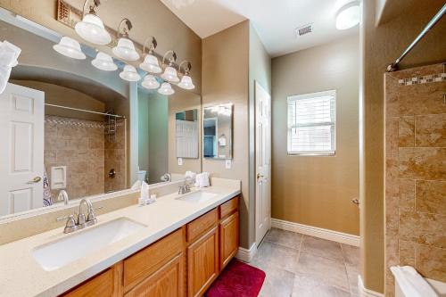 a bathroom with two sinks and a large mirror at Desert Sanctuary in Litchfield Park