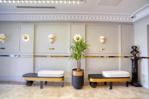 a room with two stools and a plant at İbos Hotels Izmir in Izmir