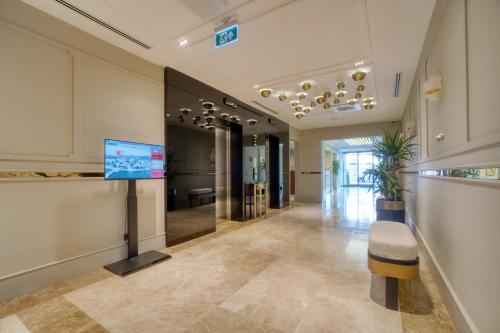 an empty lobby with a television in a building at İbos Hotels Izmir in Izmir
