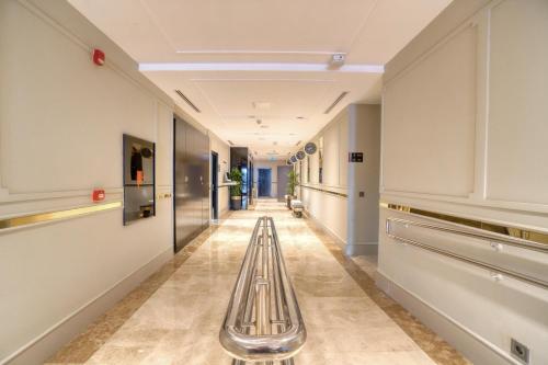 a long hallway with a bench in a building at İbos Hotels Izmir in Izmir