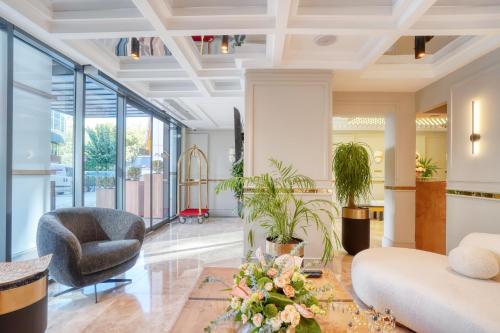 a living room with a couch and a chair at İbos Hotels Izmir in Izmir